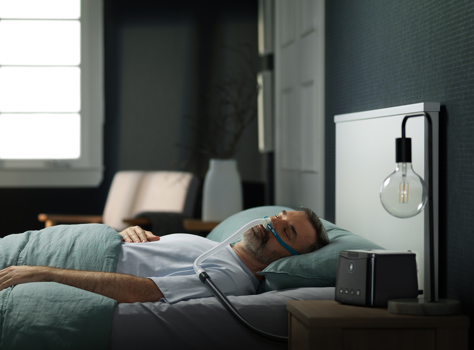 Man sleeping well using sleep device