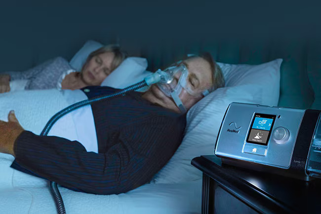 Man using ResMed machine while sleeping